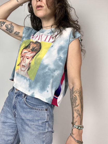 a woman wearing a tie dye shirt with a picture of a man on it.