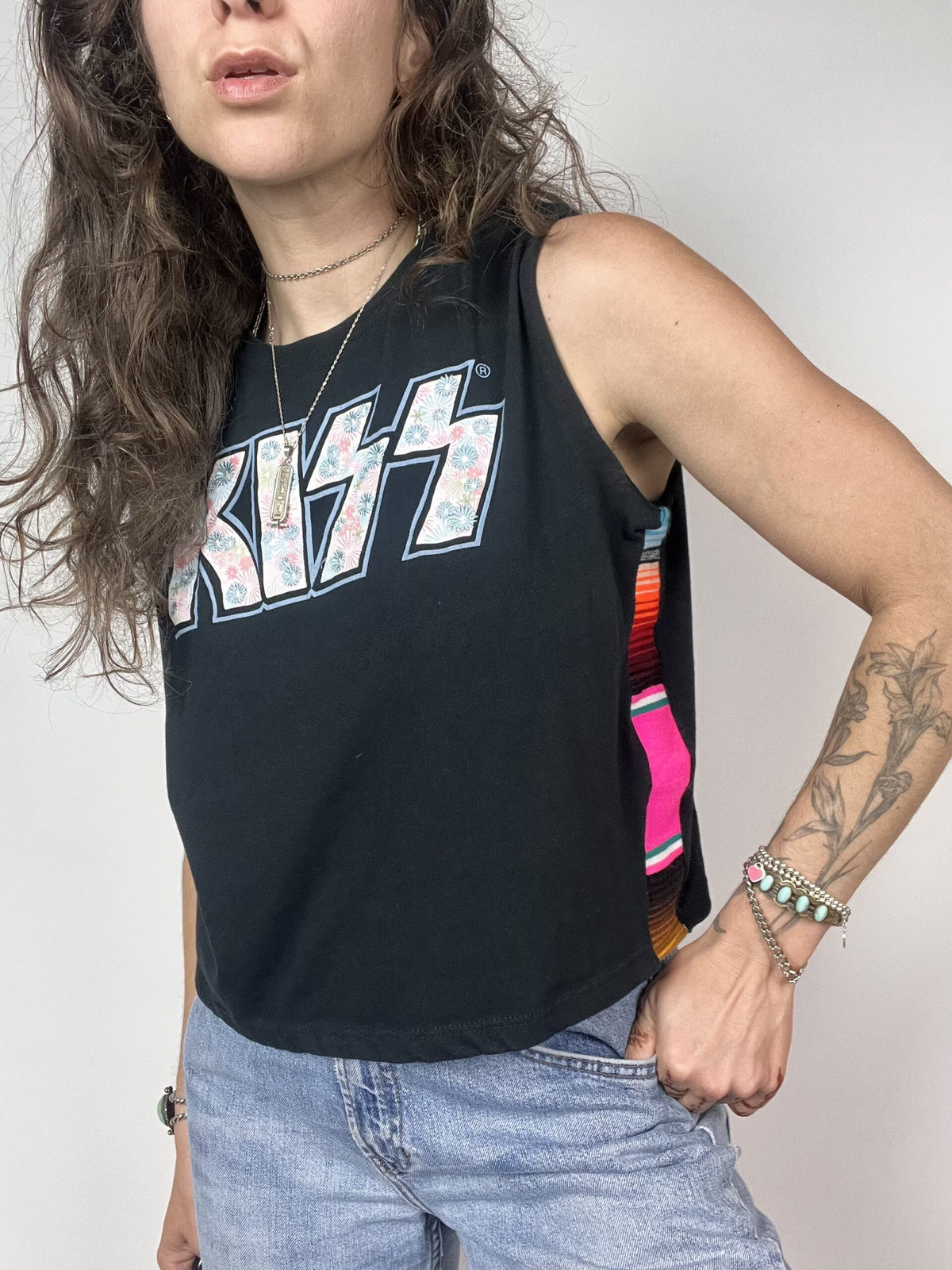 a woman with long hair wearing a black tank top.