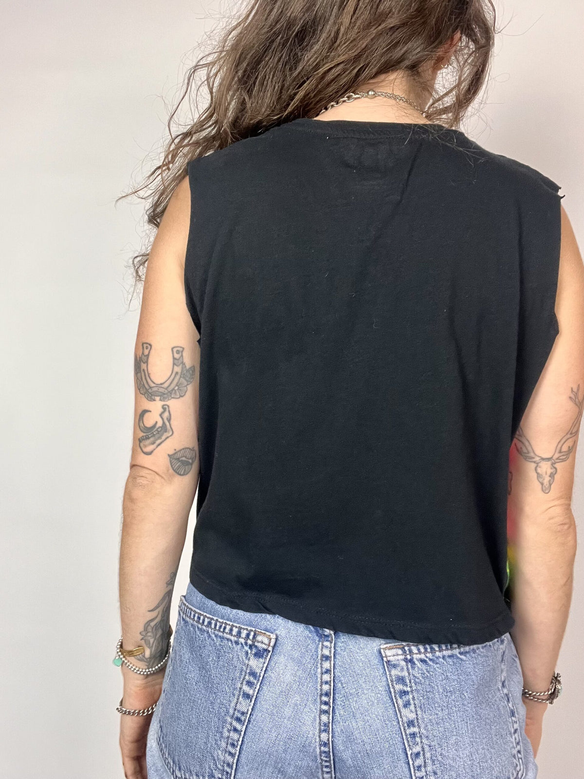 a woman with tattoos on her arms and back.