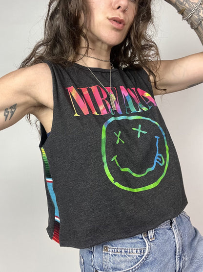 a woman wearing a black tank top with a smiley face on it.