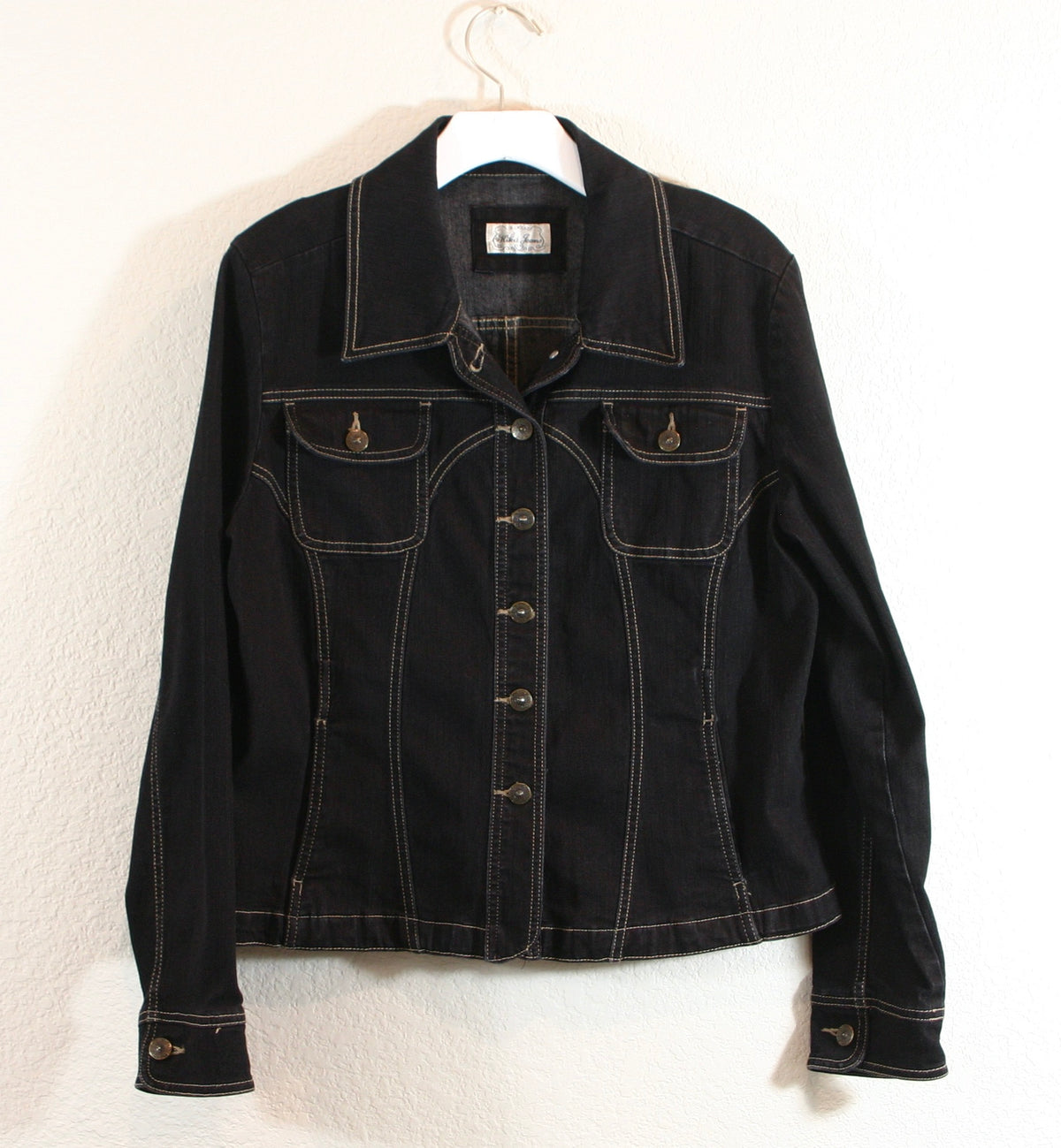 A black jacket on a white wall.