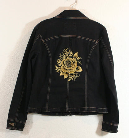 A black denim jacket with a gold rose embroidered on it.