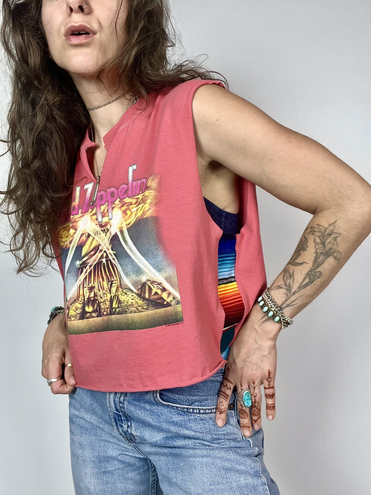 a woman with long hair wearing a pink shirt.