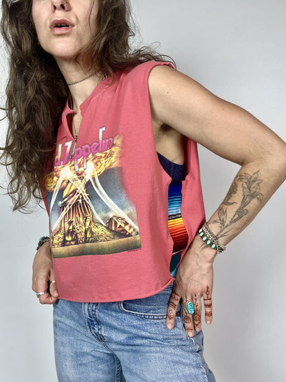 a woman with long hair wearing a pink shirt.