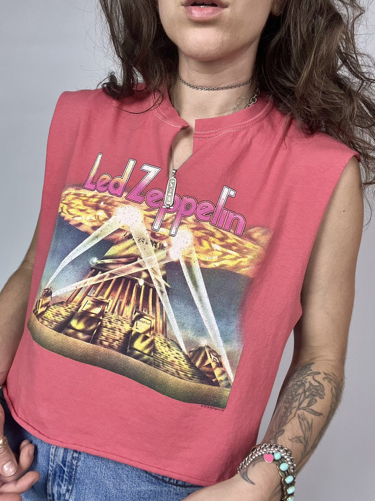 a woman wearing a pink shirt with a picture on it.