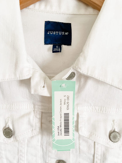 A white denim jacket with a tag on it.