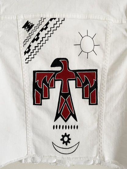 A white denim jacket with a red and black eagle on it.