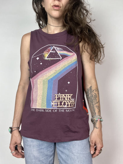 a woman with long hair wearing a tank top.