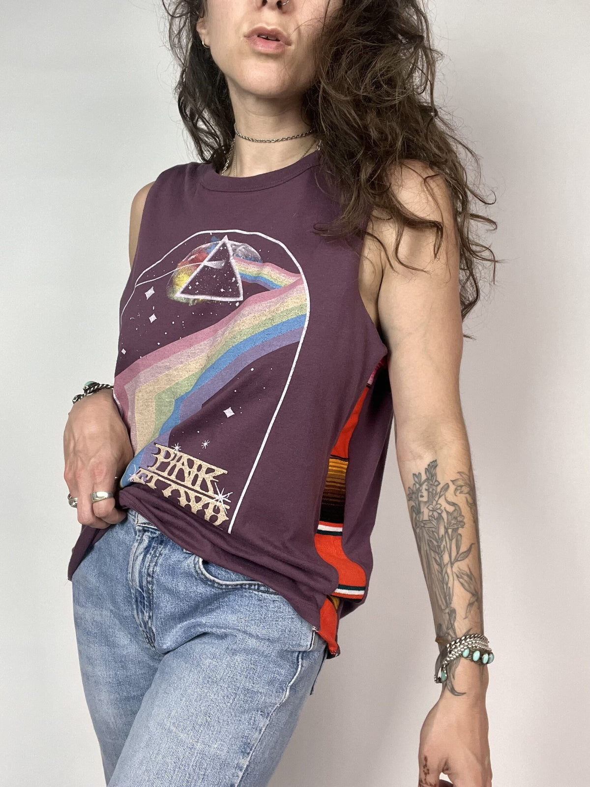 a woman with long hair wearing a tank top.