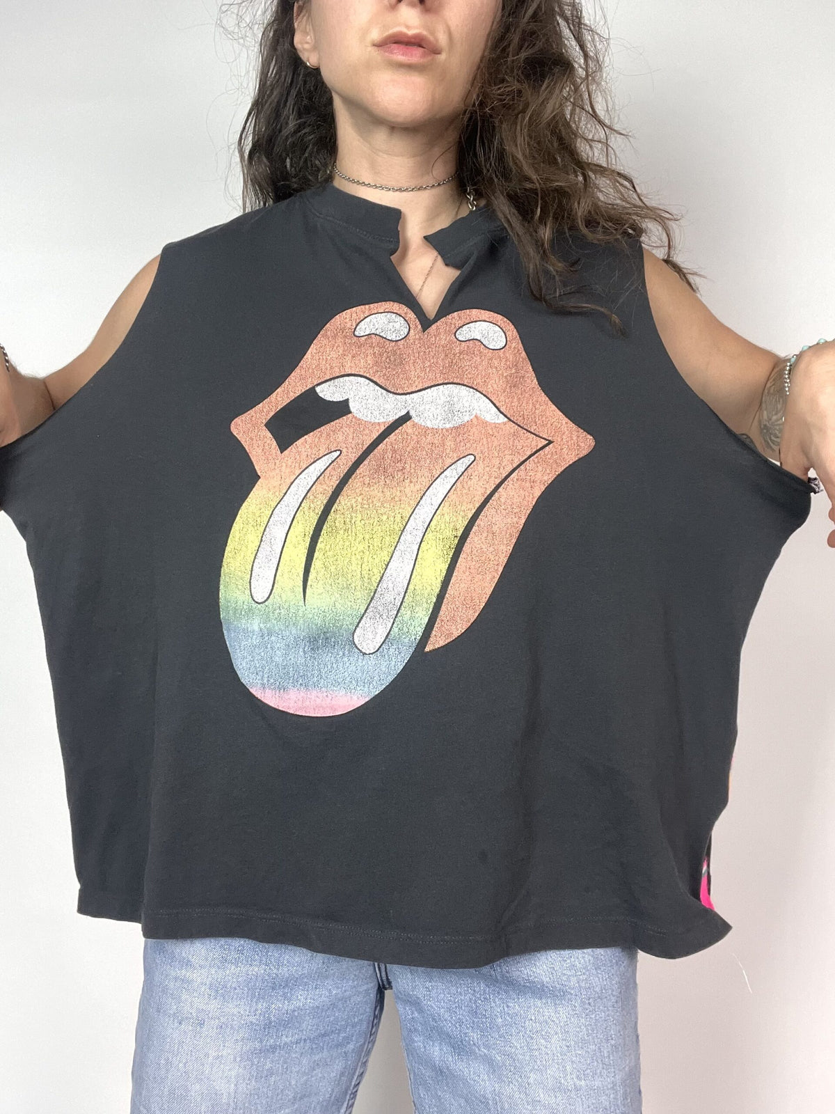 a woman wearing a black shirt with the rolling stones on it.
