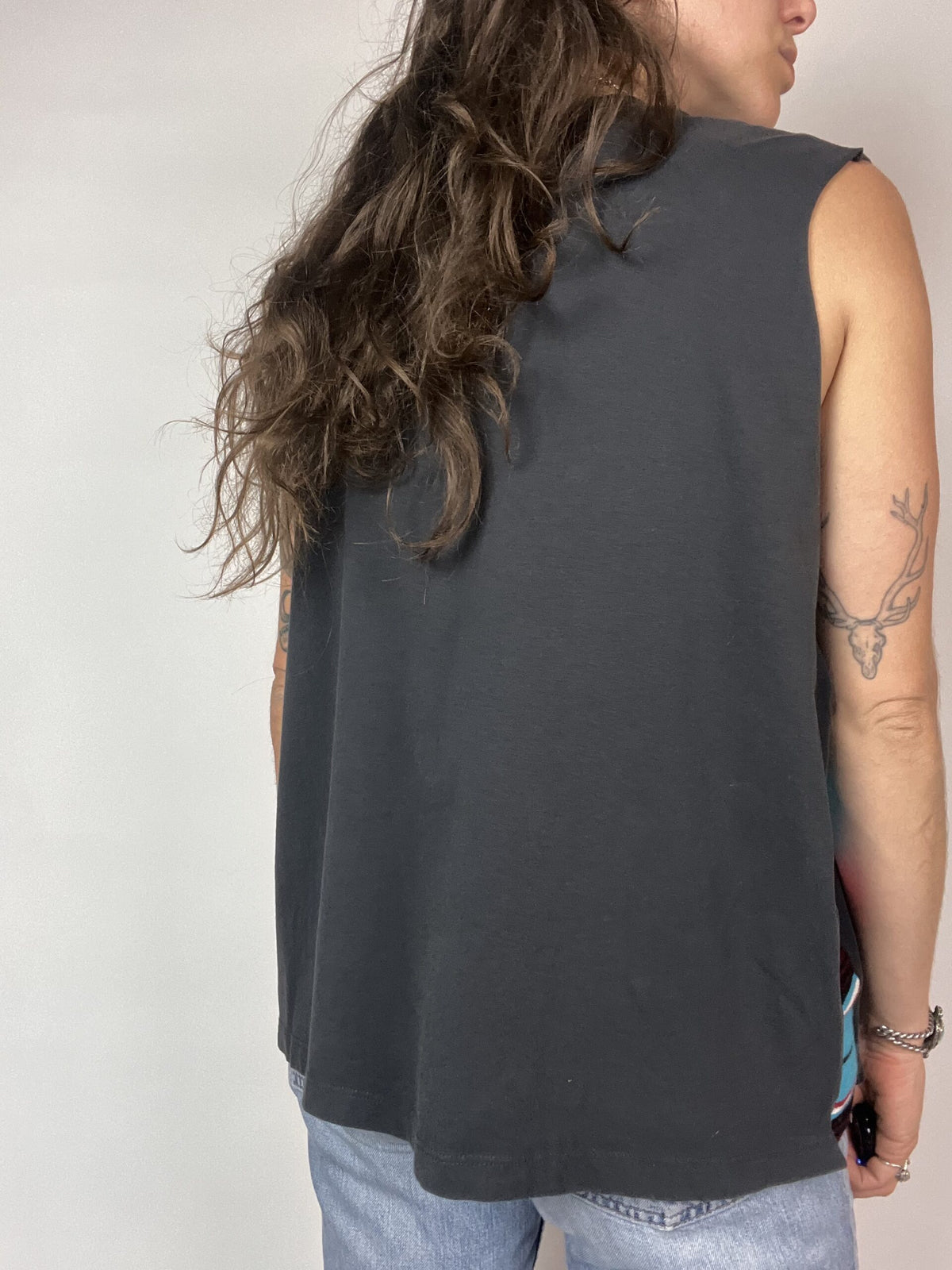 a woman with long hair wearing a gray shirt.
