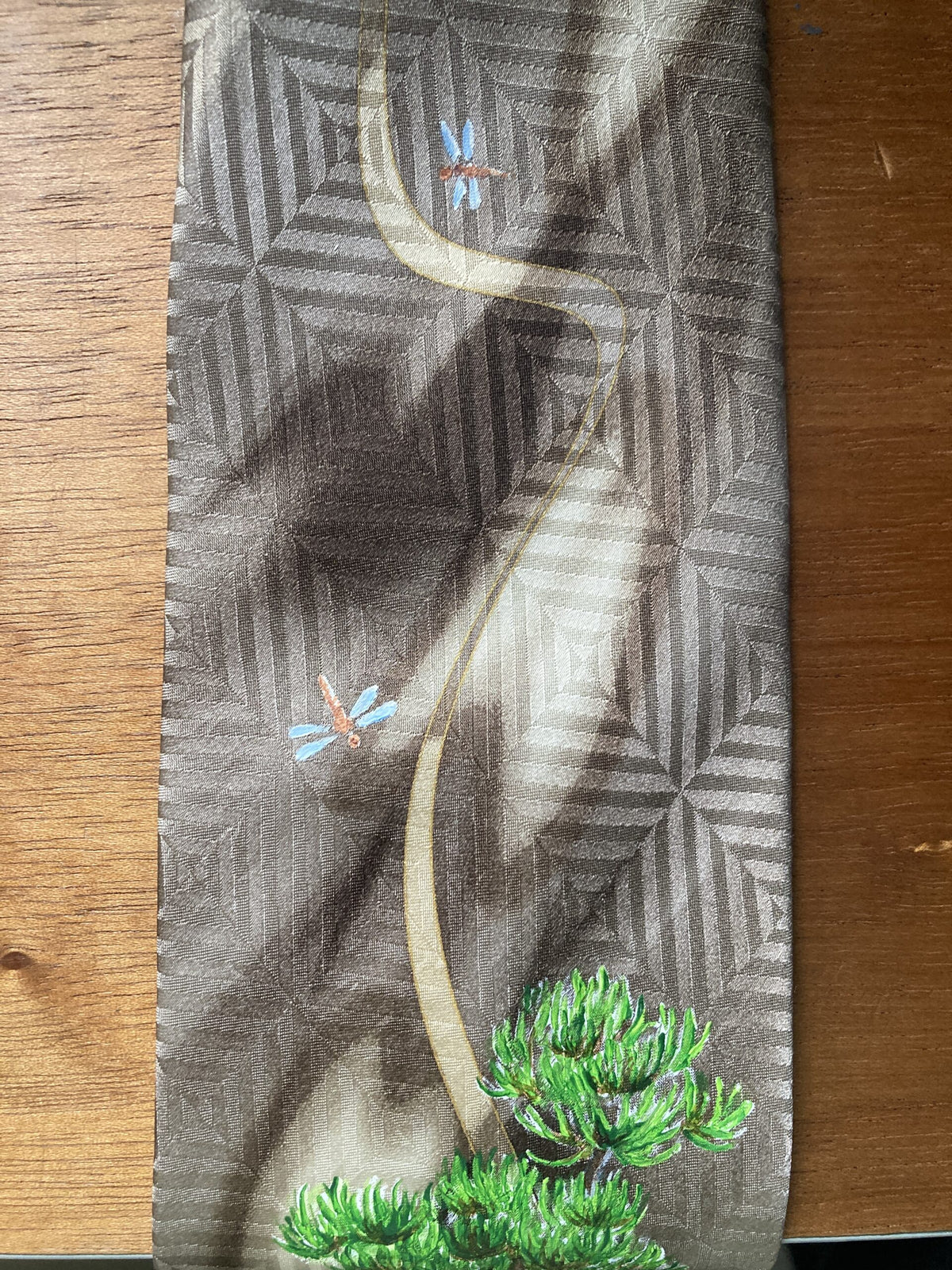 a tie with a picture of a dragon on it.
