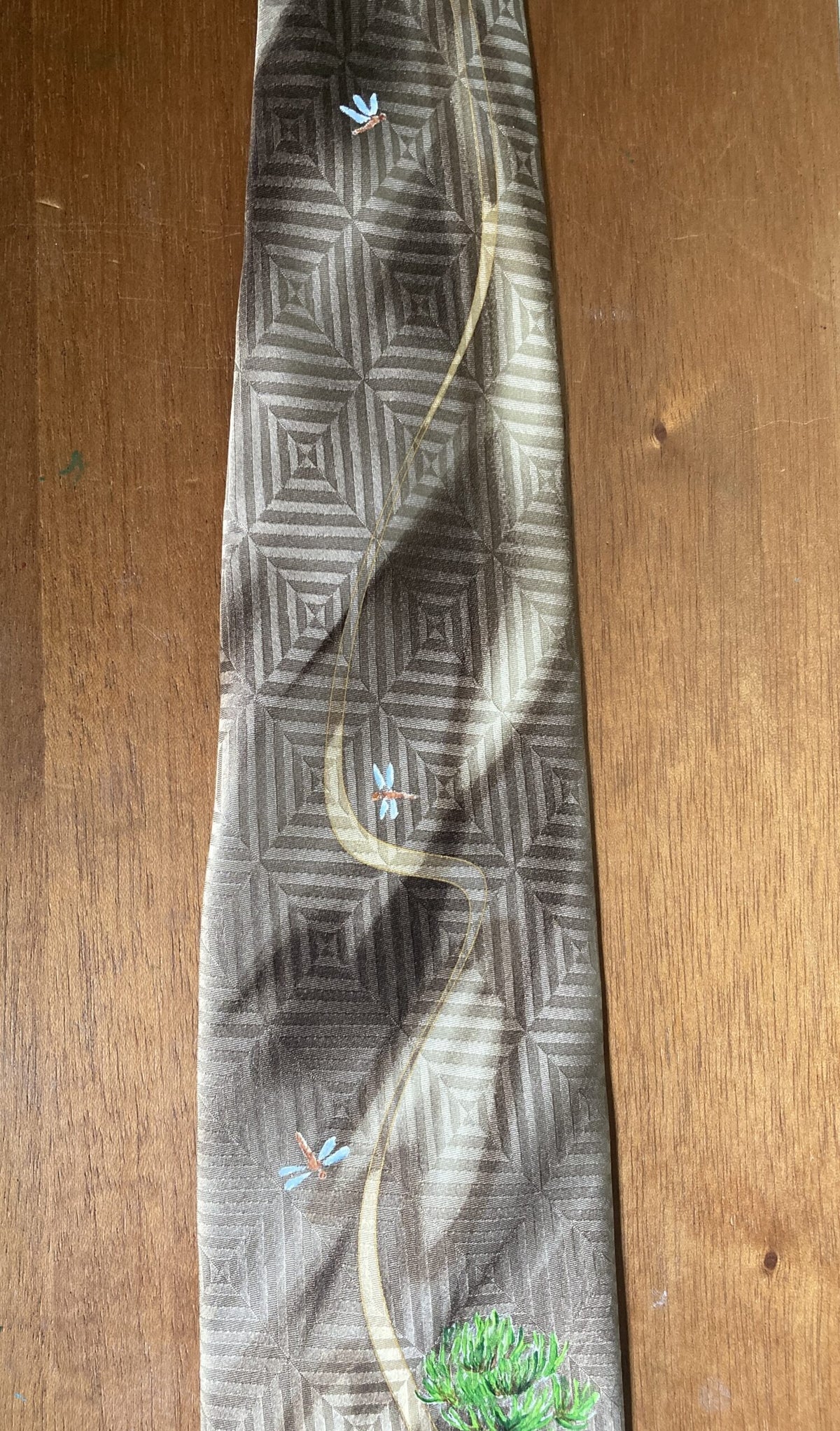 a tie with a picture of a tree on it.