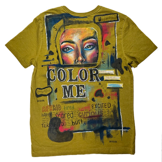 A Color Me T-Shirt with a painting of a woman's face.