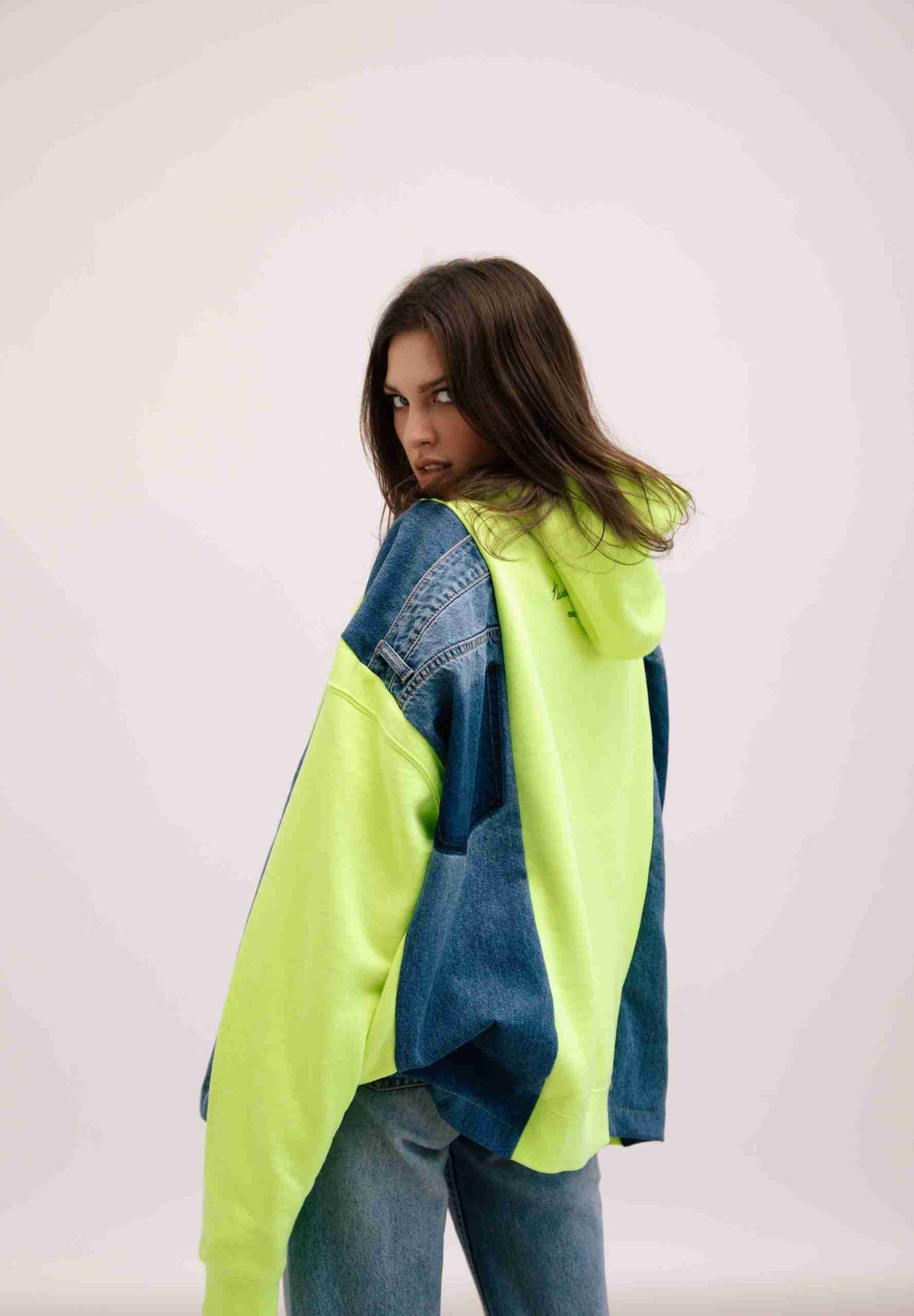 a woman wearing a yellow and blue jacket.