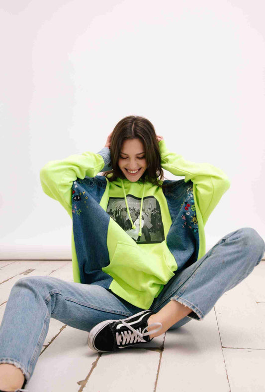 a woman sitting on the floor with her hands behind her head.