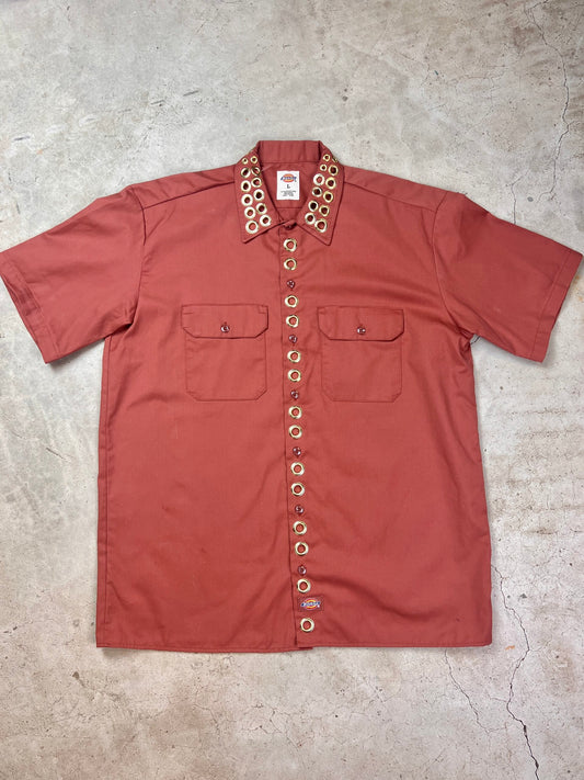A red shirt on a concrete surface.