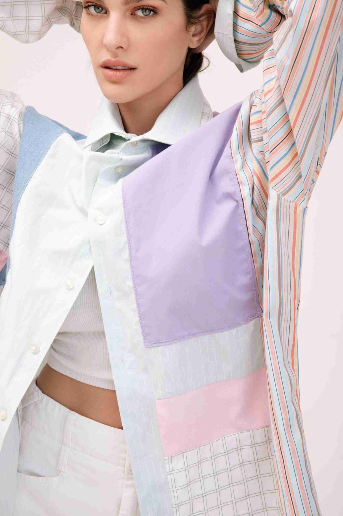 a woman in a white shirt and purple and blue shirt.