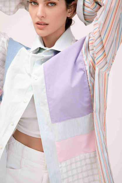 a woman in a white shirt and purple and blue shirt.