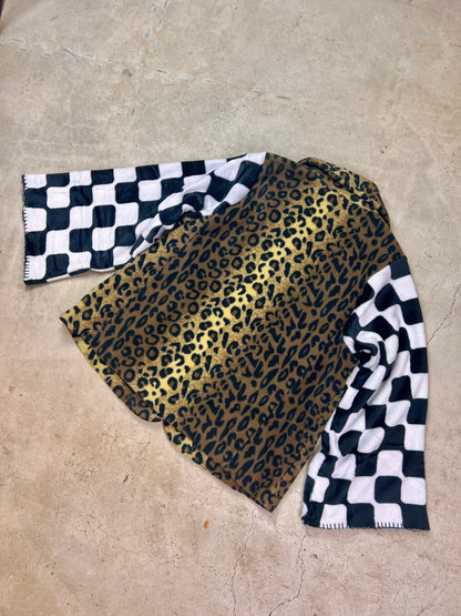 A leopard print coat on a concrete surface.