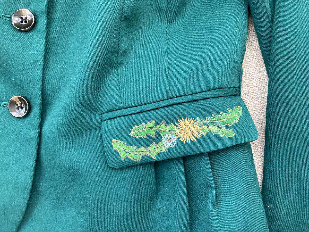 A green jacket with a flower hand-painted on it.