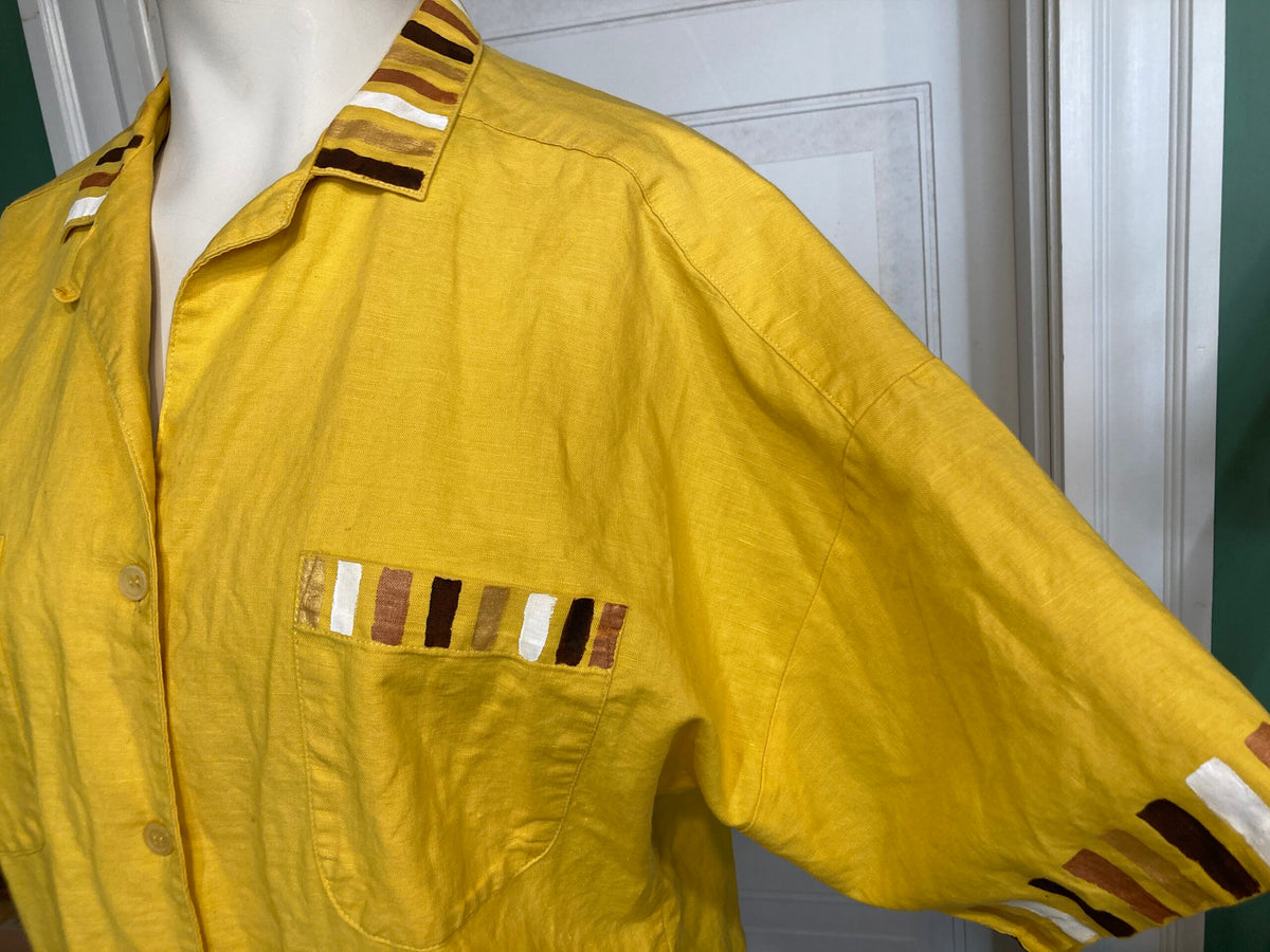 A yellow shirt on a mannequin mannequin.