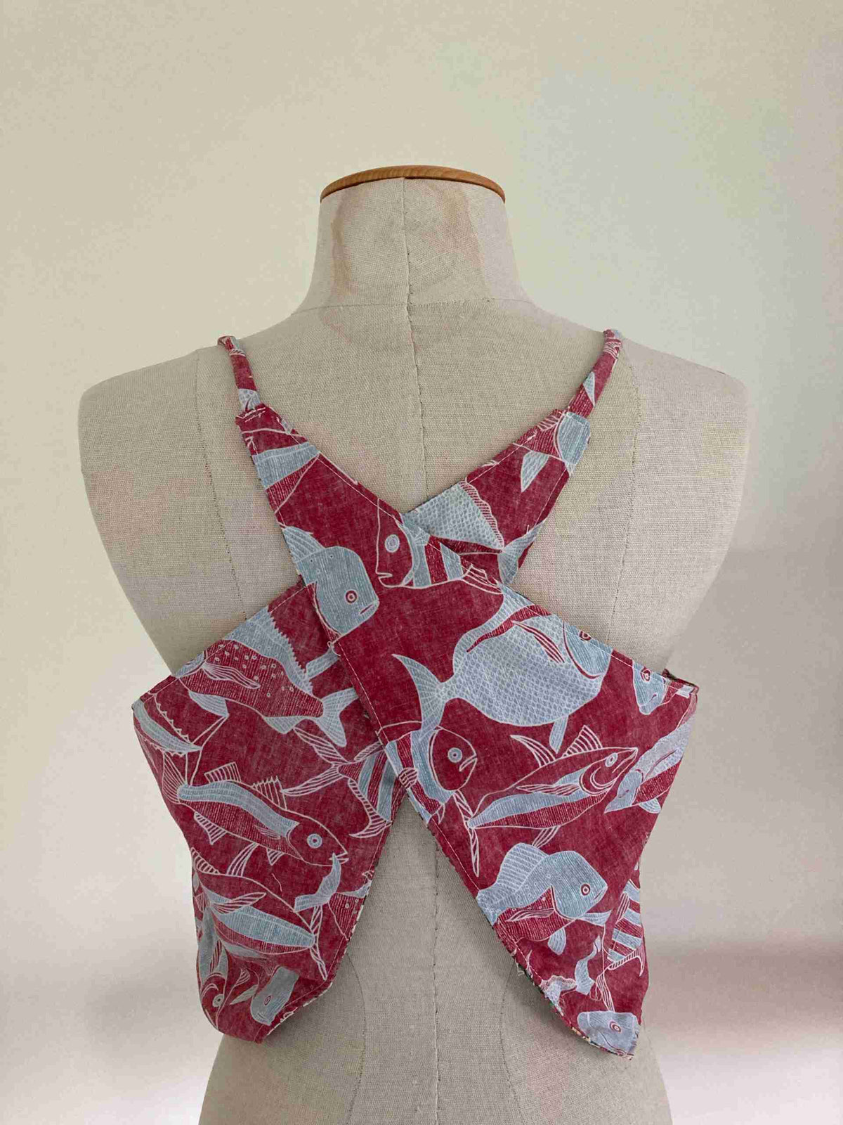 a mannequin wearing a red and white neck tie.