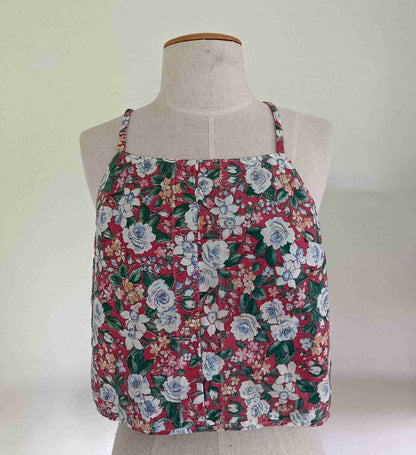 a mannequin wearing a red floral top.