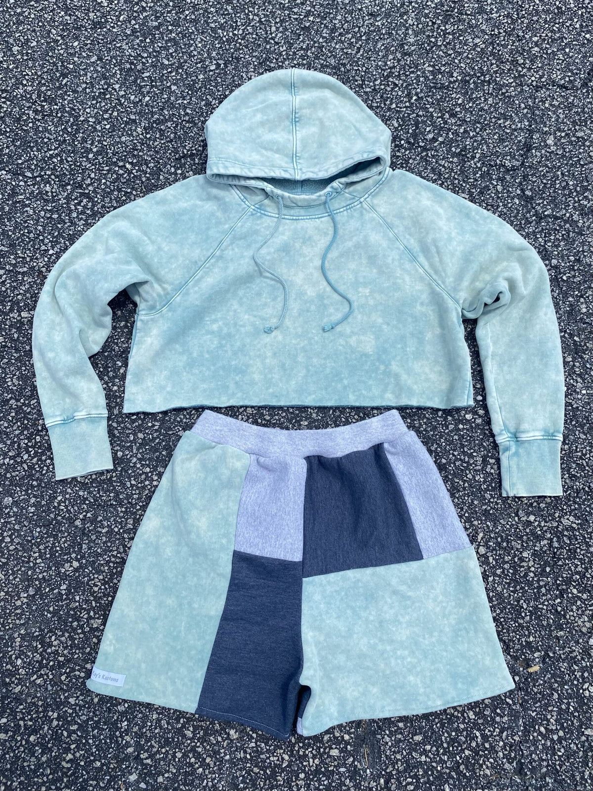 A cropped hoodie and shorts in a light blue color.