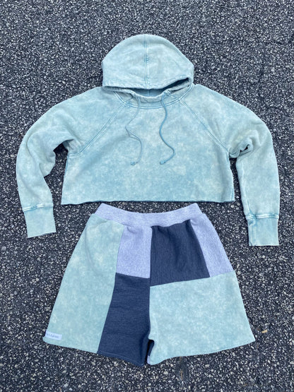 A cropped hoodie and shorts in a light blue color.