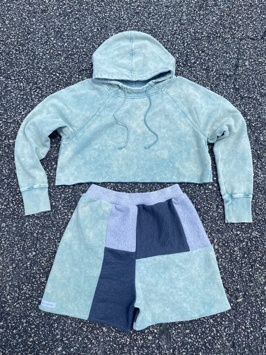 A cropped hoodie and shorts in a light blue color.