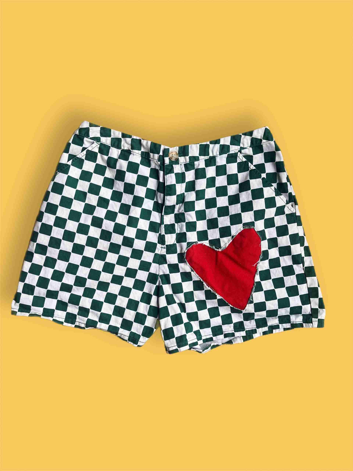 a black and white checkered shorts with a red heart.
