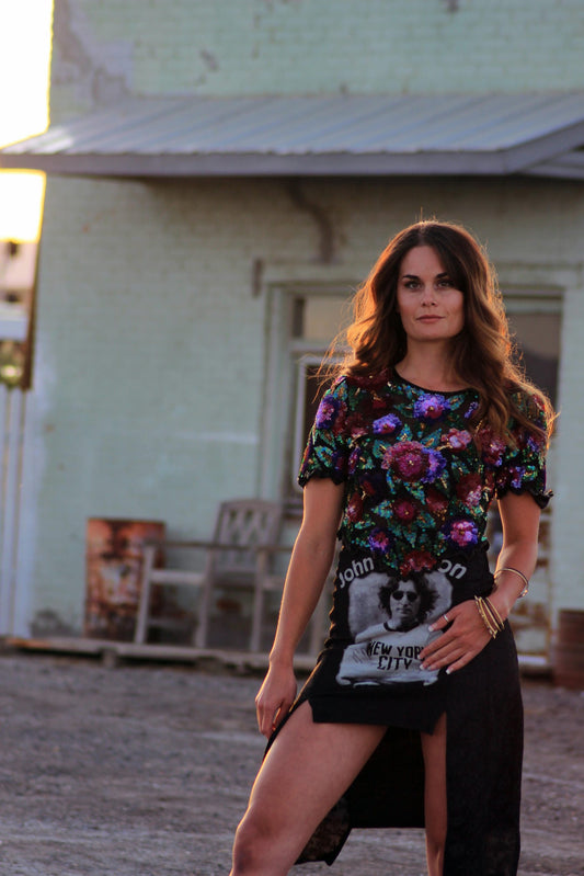 a woman wearing a Beaded sequin short sleeve top standing in front of a building.