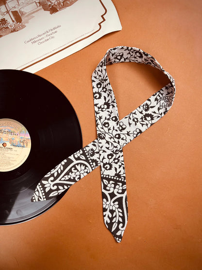 a record and a tie on a table.