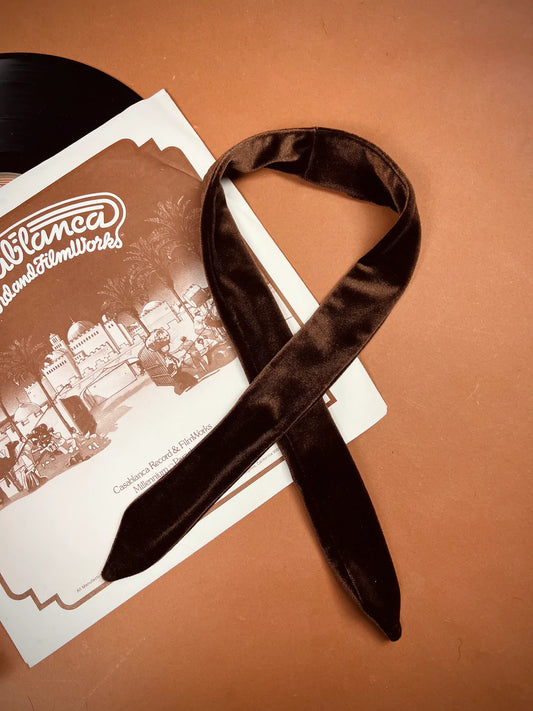 a black ribbon laying on top of a record.
