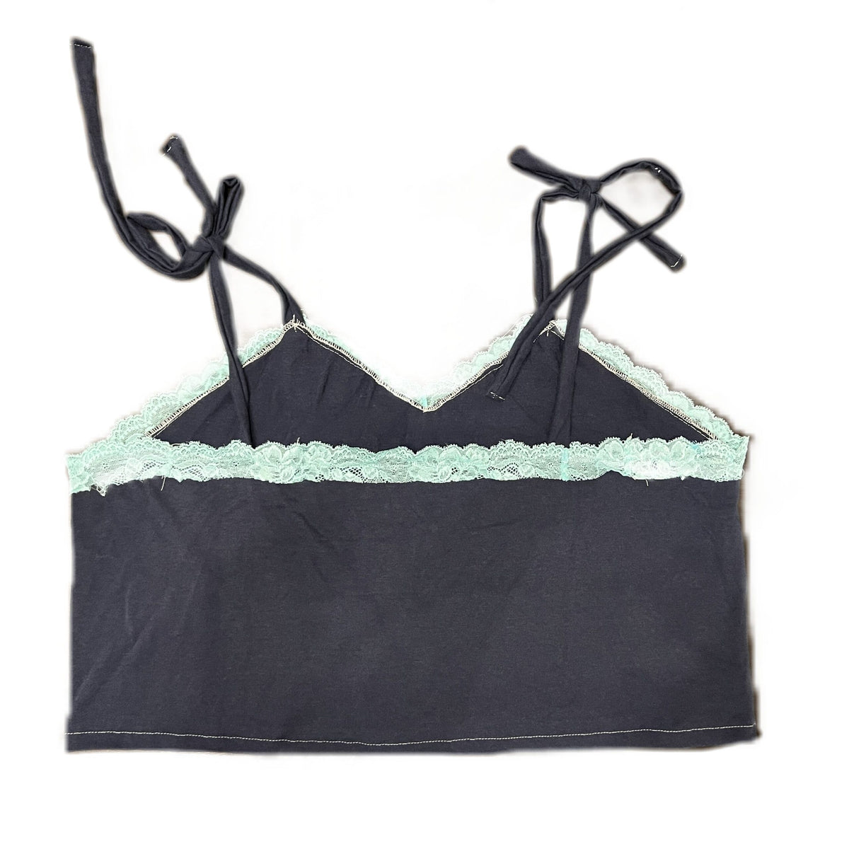 A black bra top with green trim.