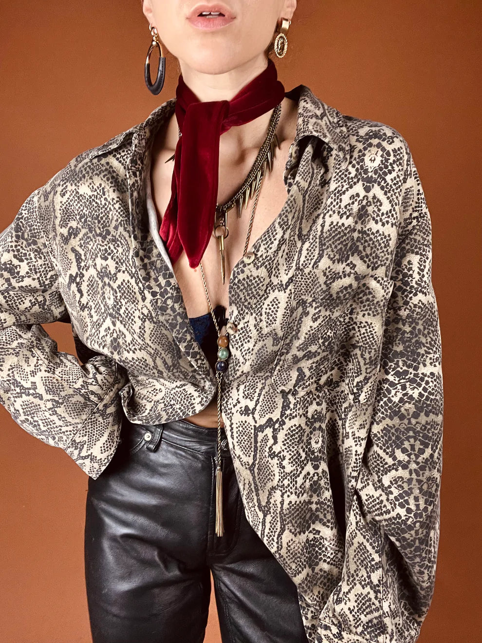 a woman wearing a red neck tie and black pants.