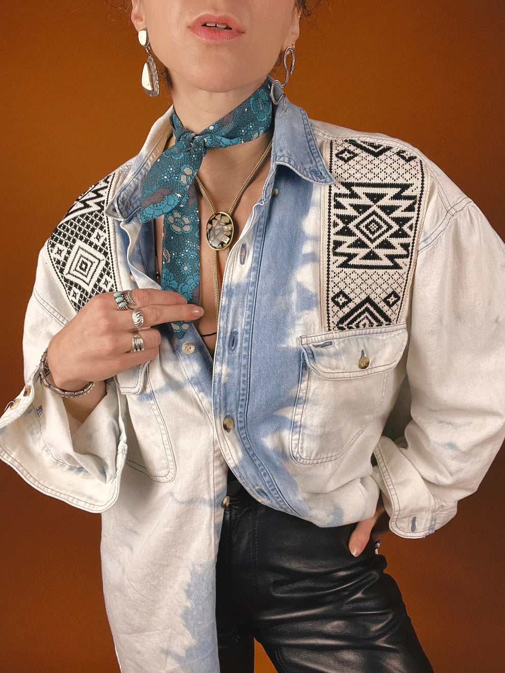 a woman wearing a tie and a denim shirt.