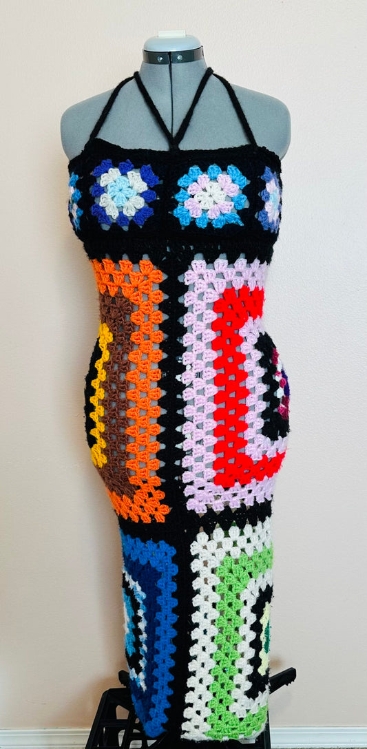 A crocheted dress on a mannequin dummy.