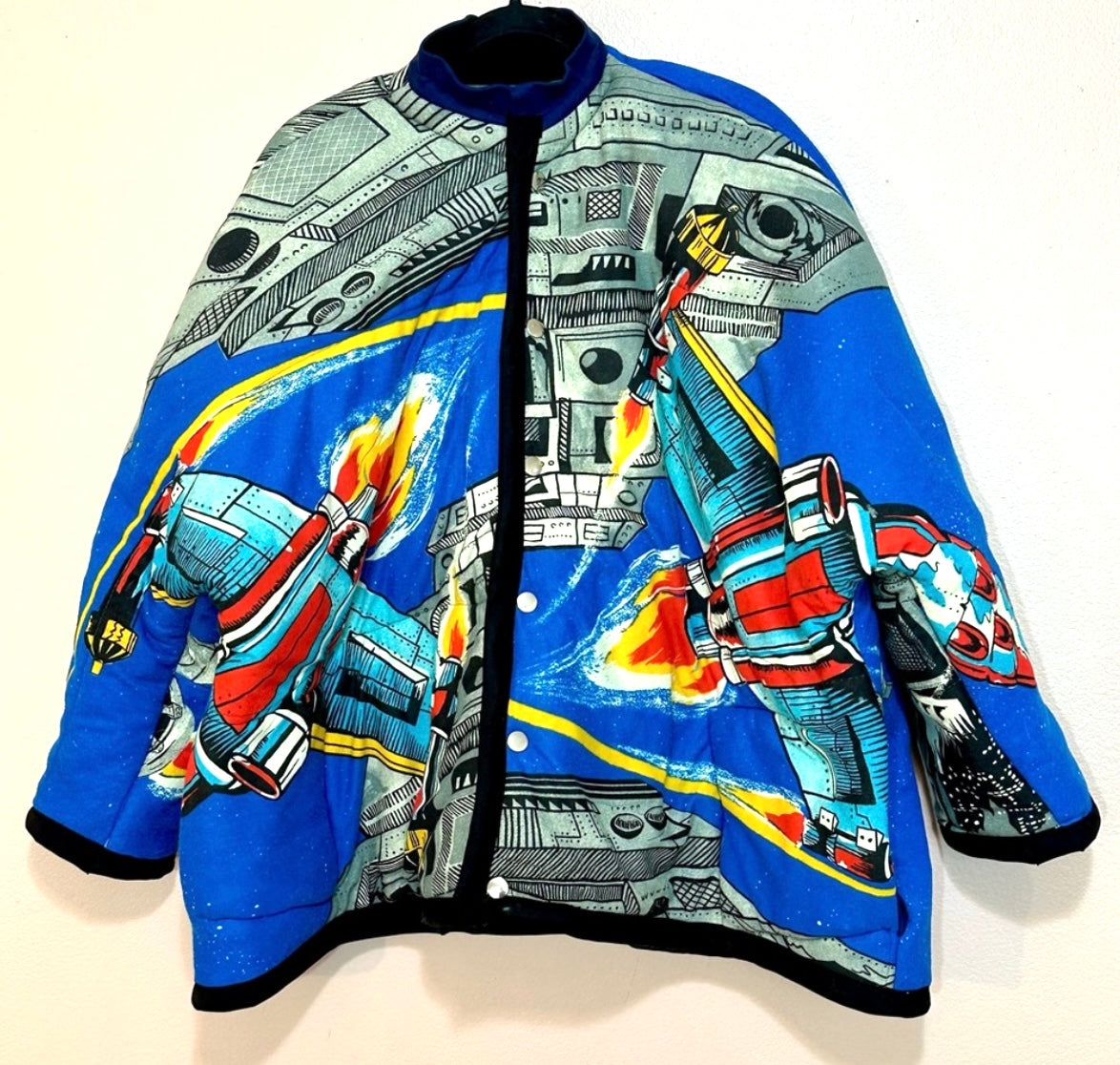 A blue jacket with a star wars design on it.
