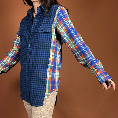 A woman in The Plaid Flannel Mash Up Shirt In Blue/Orange and tan pants.