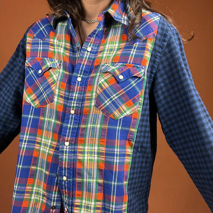 a woman wearing a plaid shirt with a frisbee in her hand.