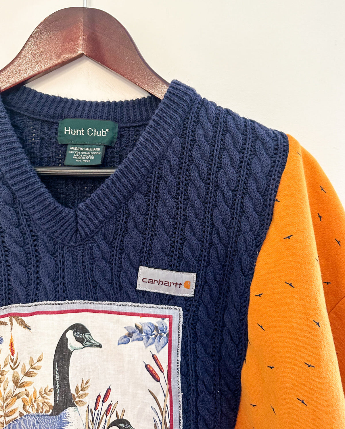 A sweater with an image of geese on it.