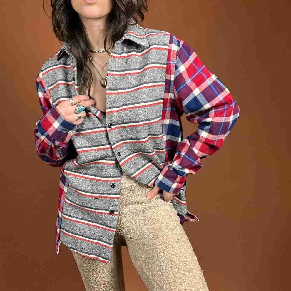 a woman posing for a picture in a plaid shirt.