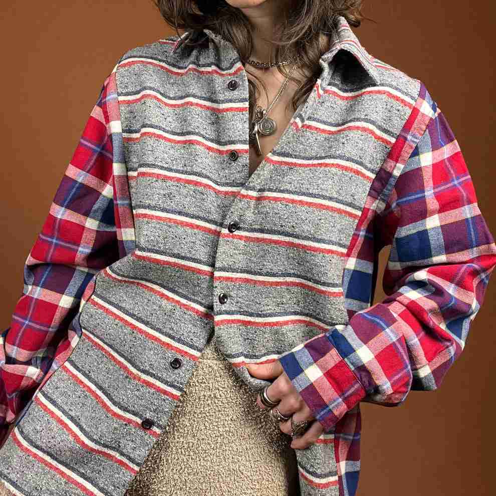 a woman in a plaid shirt is posing for a picture.