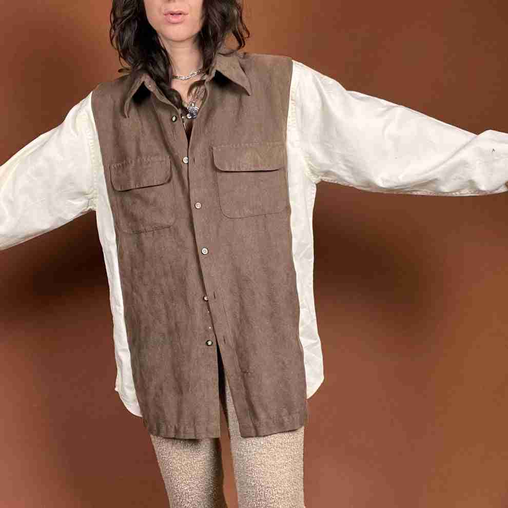 a woman wearing a brown vest and white shirt.