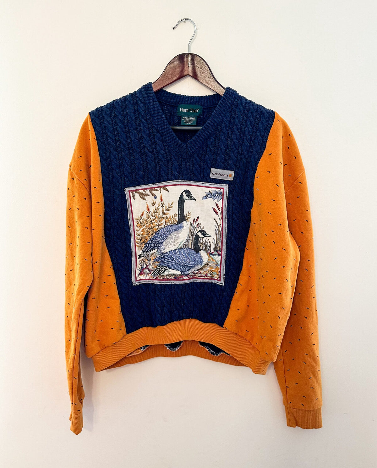 A sweater with an image of a goose on it.