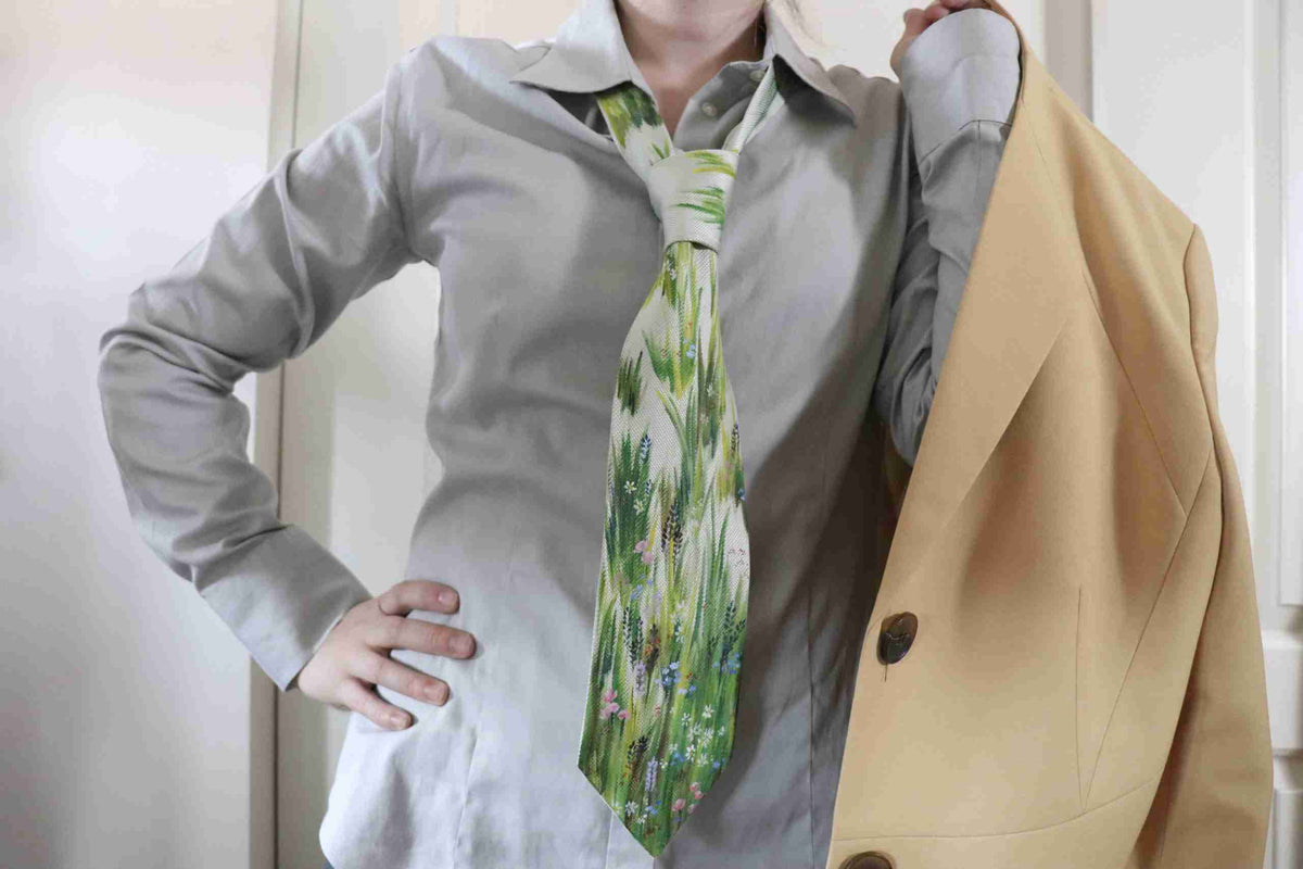a woman wearing a suit and a tie.