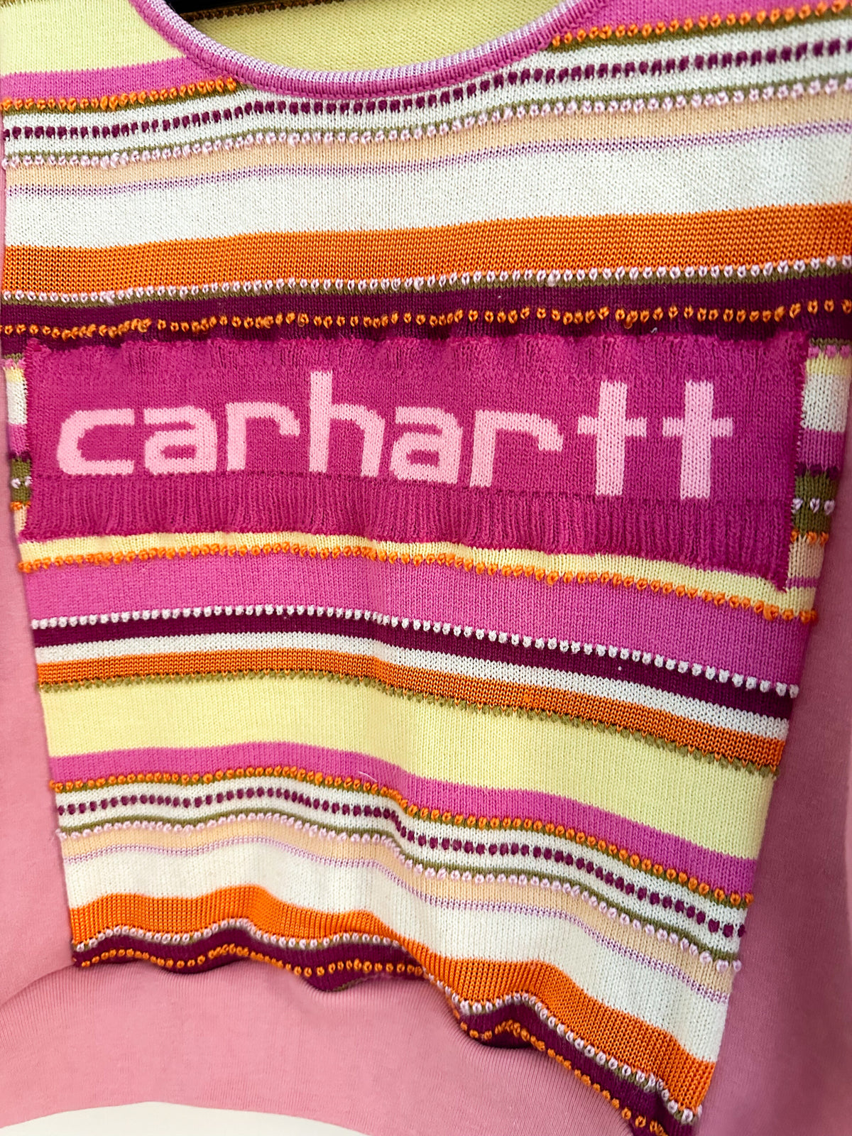 A pink and orange sweater with the word carhartt on it.