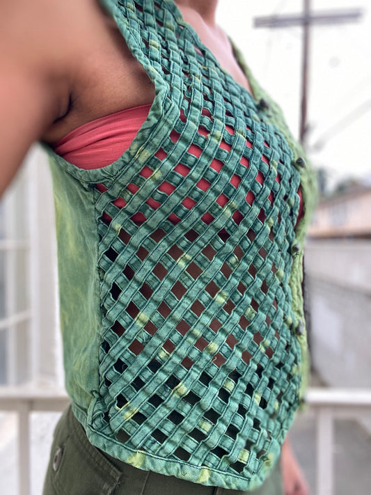 A woman wearing a green tie dye vest.